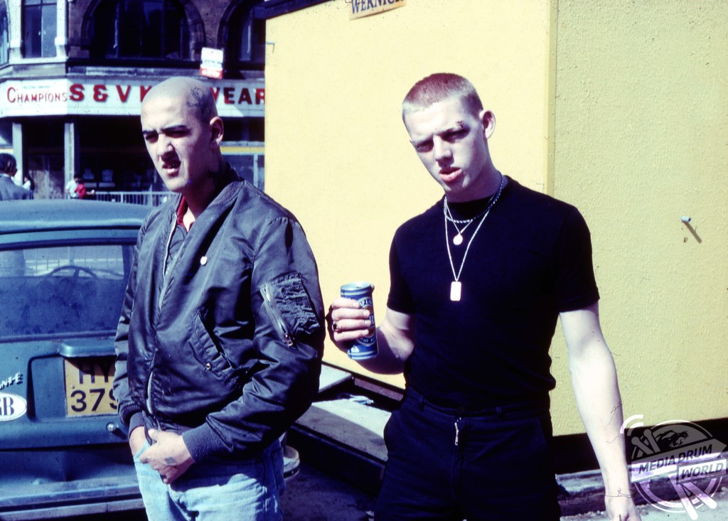 Two skinheads practice their menacing stares. 