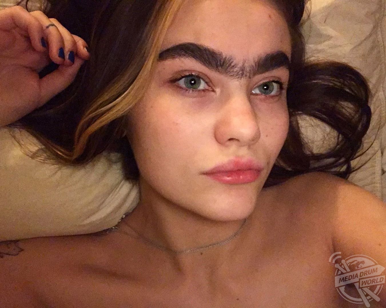 Sarah pictured lying down showing off her unibrow. 