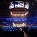A boxing ring under bright lights in a packed indoor arena