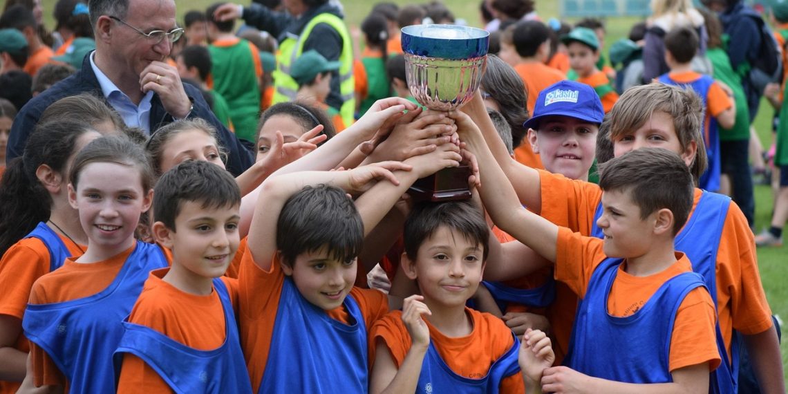 Footballers celebrating with a trophy after winning a final