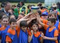 Footballers celebrating with a trophy after winning a final