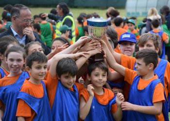 Footballers celebrating with a trophy after winning a final