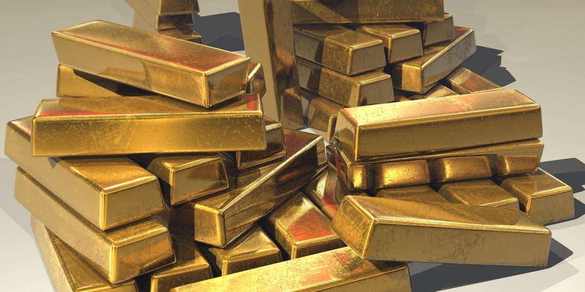 Gold bars resting on moss on a forest floor