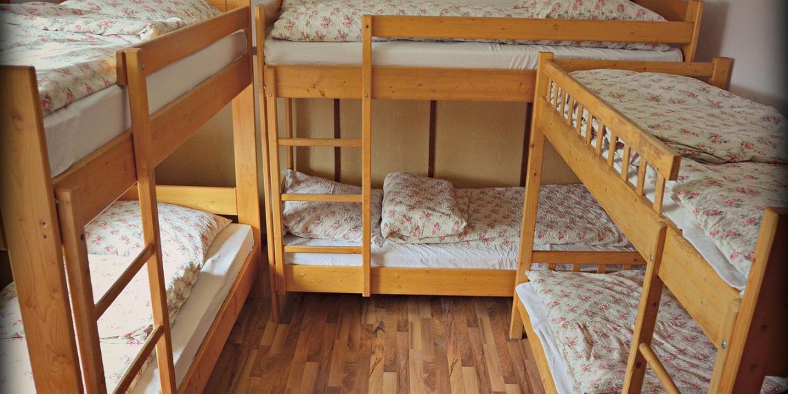 A made-up bed in a bright holiday rental bedroom