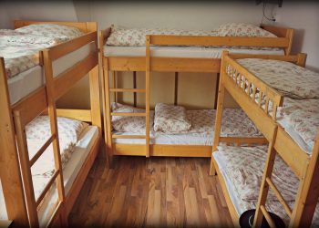 A made-up bed in a bright holiday rental bedroom