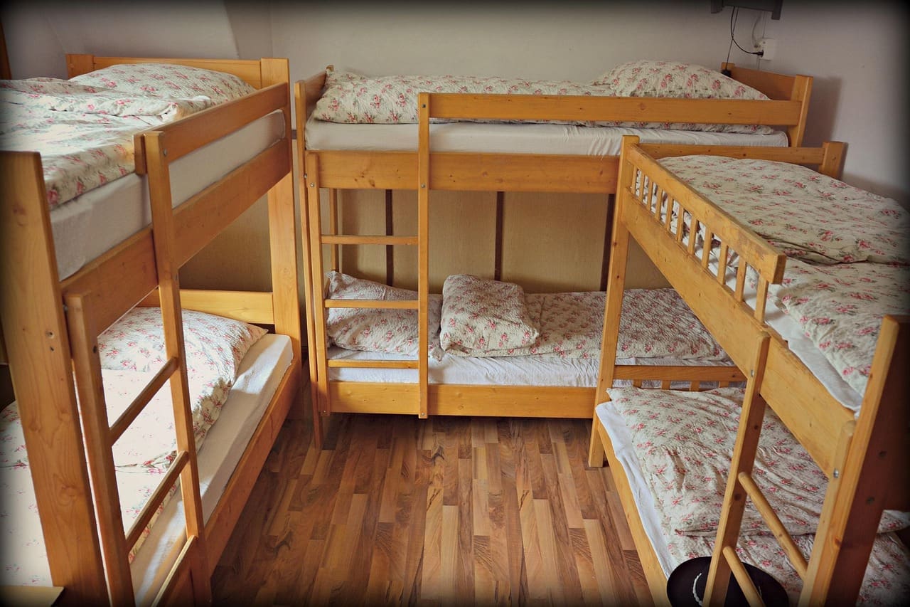 A made-up bed in a bright holiday rental bedroom