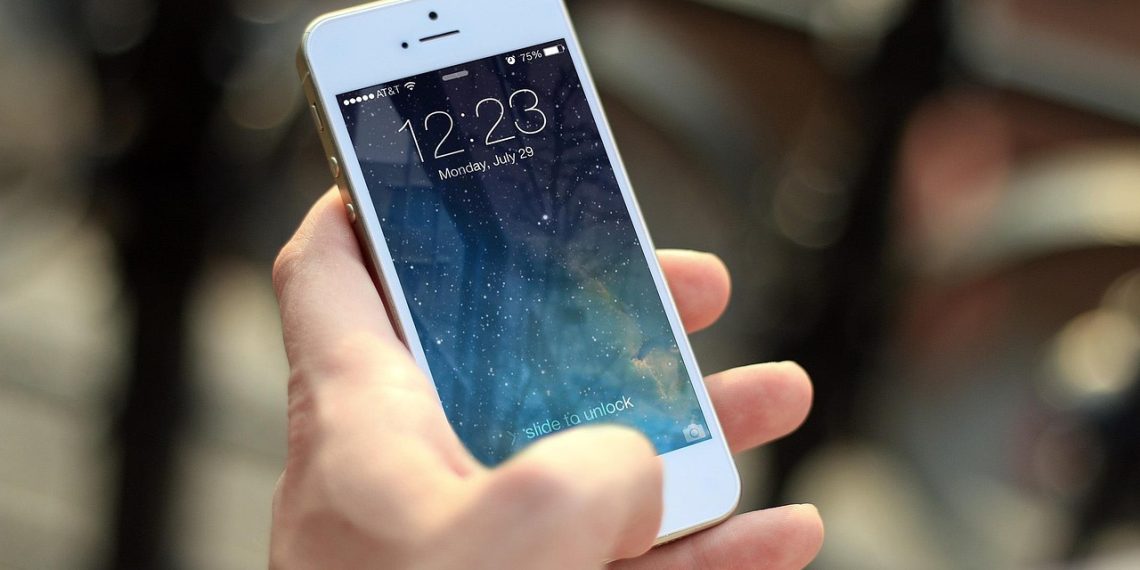 Person looking at a dating app conversation on a smartphone