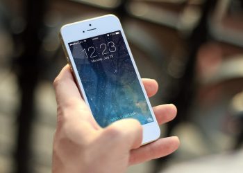 Person looking at a dating app conversation on a smartphone
