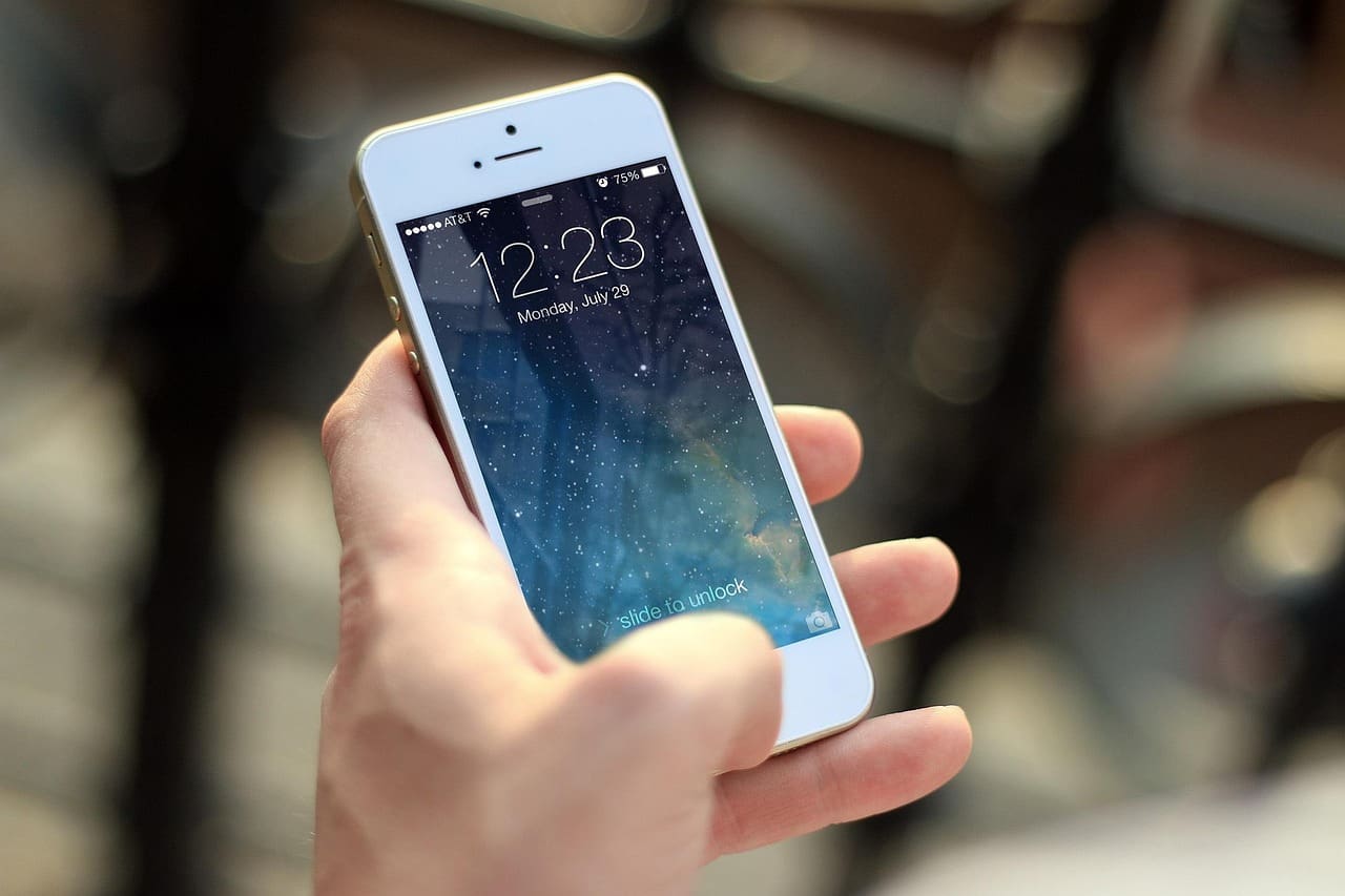 Person looking at a dating app conversation on a smartphone
